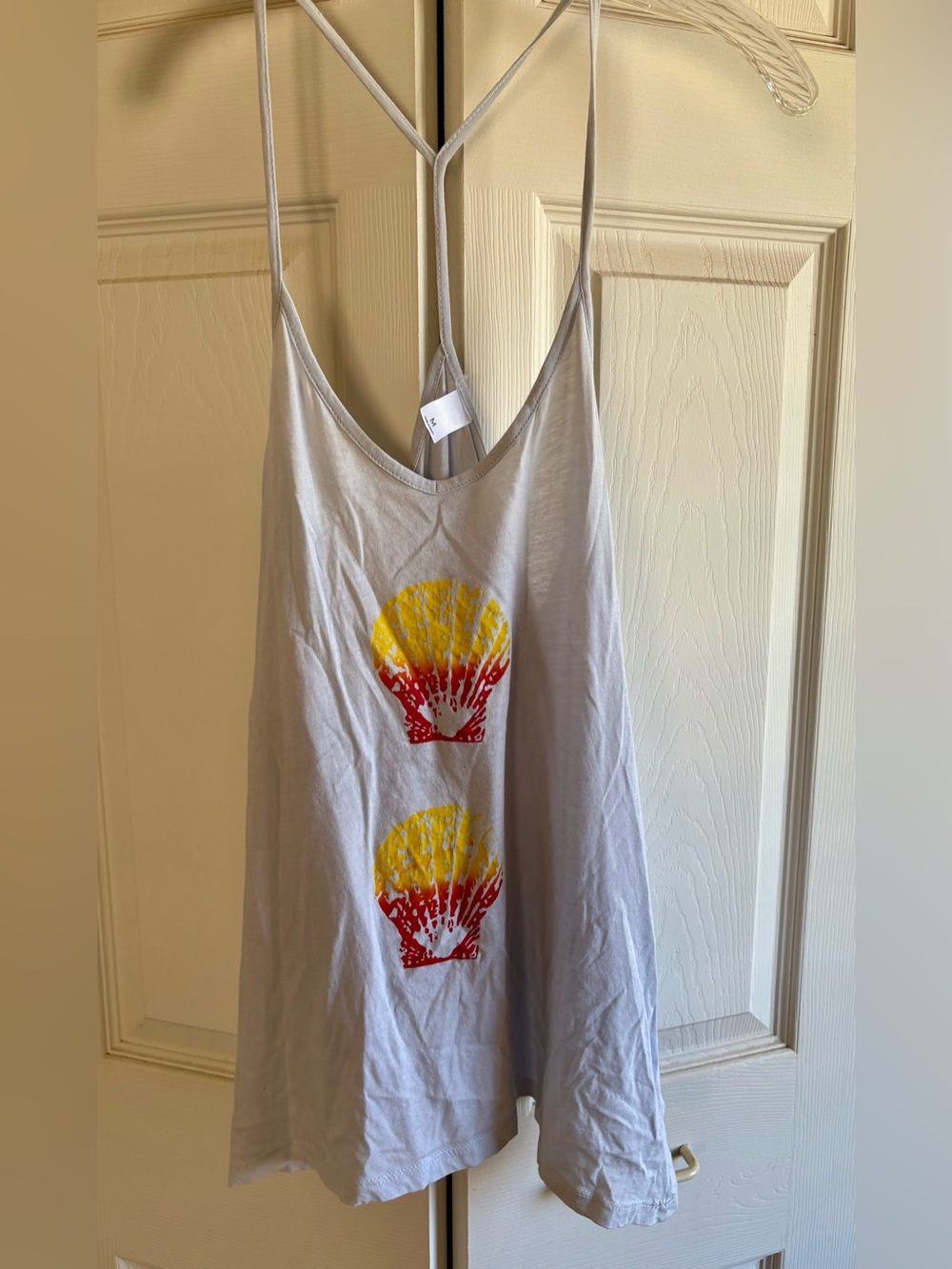Spaghetti strap, racer back style tank with Sunrise Shell design.